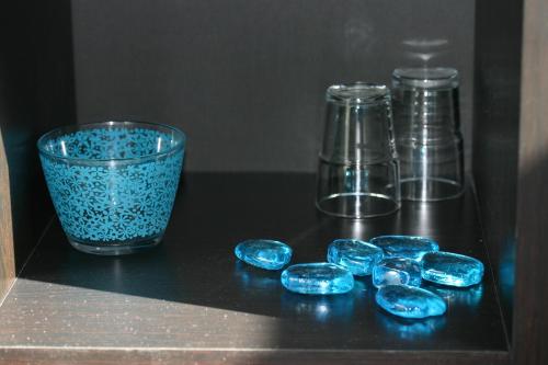 a group of blue glass items sitting on a table at la Grange de Félicie in Charrey-sur-Saône