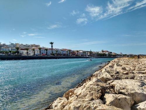 a view of a beach with rocks and buildings at Casa Azul in Barão de São João
