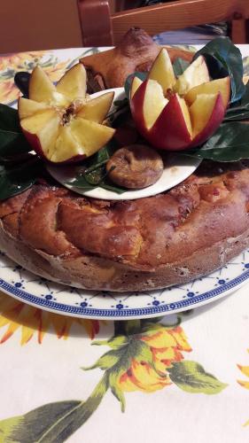 a plate of food with apples on a table at "LA TAVERNA" B&B in Airuno