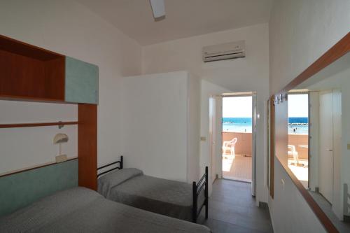 a bedroom with two beds and a view of the beach at Hotel VistaMare Viserba in Rimini