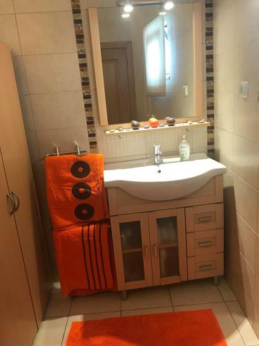 a bathroom with a sink and a mirror at Sun Place Guest House in Lagos