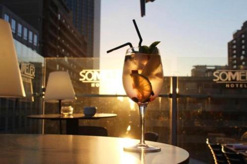 a drink sitting on a table in front of a window at Hotel Sommelier Boutique in Santiago