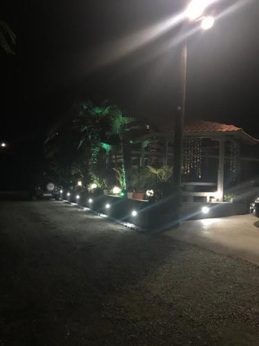 a row of lights in front of a building at night at Hotel Medousa in Skála Alykís