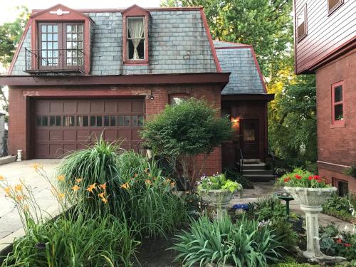 a house with a garage and some plants at Vineyard Mansion Carriage House in Saint Joseph