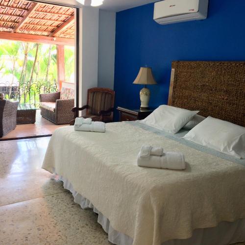 a bedroom with a bed with two towels on it at Hotel Boutique Villa Casuarinas in Cali