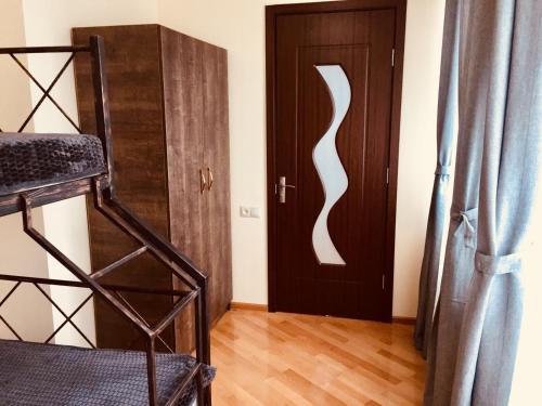 a room with a bunk bed and a door at Asterias Apartment in Tbilisi City