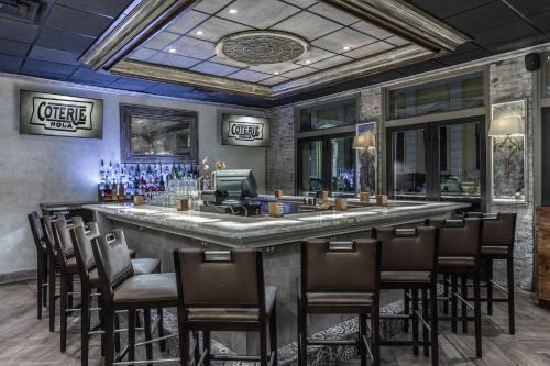 a bar in a restaurant with a lot of chairs at La Galerie French Quarter Hotel in New Orleans