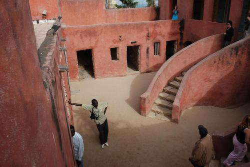 a man standing on the side of a building at Safari Village Saly V 225 in Saly Portudal