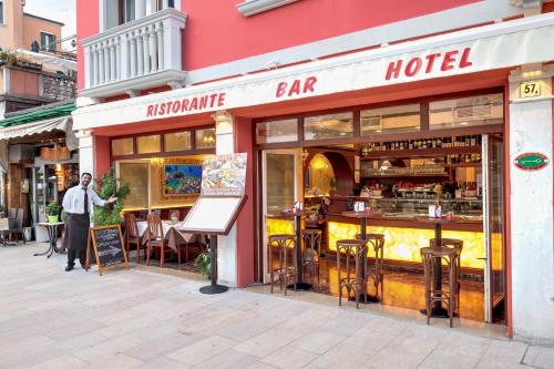 a man standing in front of a hotel at New Reiter Hotel in Venice-Lido
