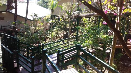 a green stairway with a bench in a garden at King Solomon Hotel in Honiara