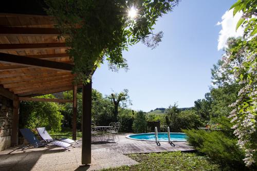 une cour avec une piscine, des chaises et une table dans l'établissement Belle maison de maître - Piscine et jardin privés - Au cœur du village médiéval de Caylus - 4 personnes - Garage, à Caylus