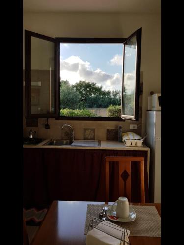 a kitchen with a sink and a window in it at La casa del melograno in Marsala