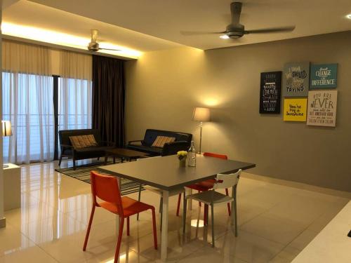 a living room with a dining room table and chairs at Setia Walk Puchong in Puchong