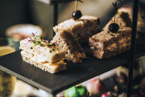 a group of desserts on a black plate at Fable Auckland, MGallery in Auckland