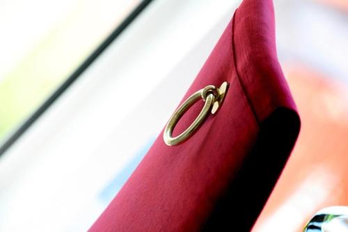 a red suitcase with a gold latch on it at Hôtel Princesse Flore in Royat