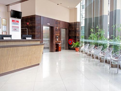 a lobby with chairs and a counter in a building at Hotel Summer View in Kuala Lumpur