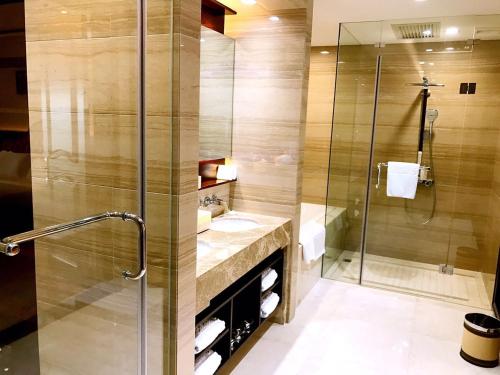 un baño con ducha y lavabo en Don Chan Palace Hotel & Convention, en Vientiane