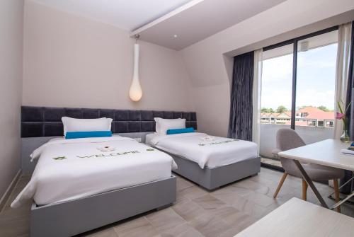 Ένα ή περισσότερα κρεβάτια σε δωμάτιο στο Damrei Angkor Hotel