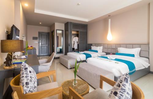 Ένα ή περισσότερα κρεβάτια σε δωμάτιο στο Damrei Angkor Hotel