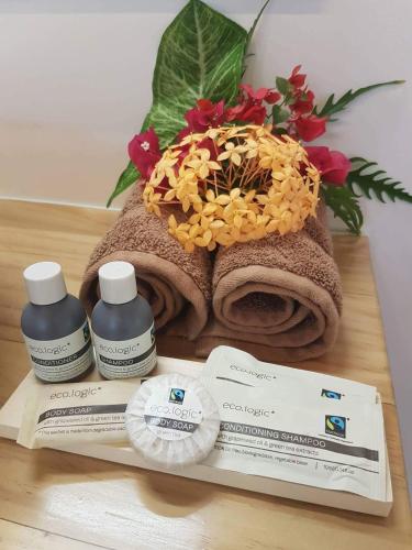a table with a pile of towels and some medicines at Mystic Sands in Utungake