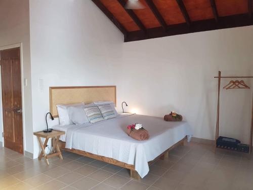 a bedroom with a large white bed with flowers on it at Mystic Sands in Utungake