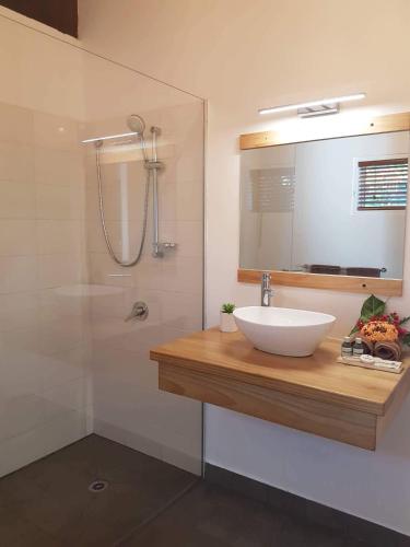 a bathroom with a sink and a shower at Mystic Sands in Utungake