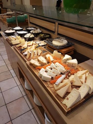 a display case with lots of different types of cheese at Shefayim Kibbutz Hotel in Kibbutz Shefayim