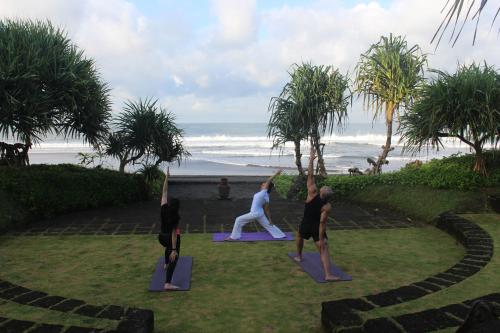 a group of people doing yoga by the beach at WakaGangga in Tabanan
