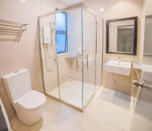a bathroom with a shower and a toilet and a sink at C Residence Labuan in Labuan