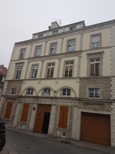 a large building with brown doors on a street at Ilot Désille in Boulogne-sur-Mer