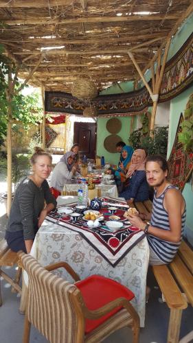 a group of people sitting around a table at Amir Hostel in Samarkand