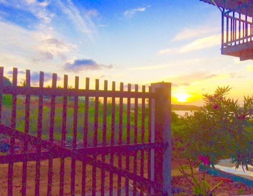 a fence with the sunset in the background at Sunntop Cabana in Trincomalee