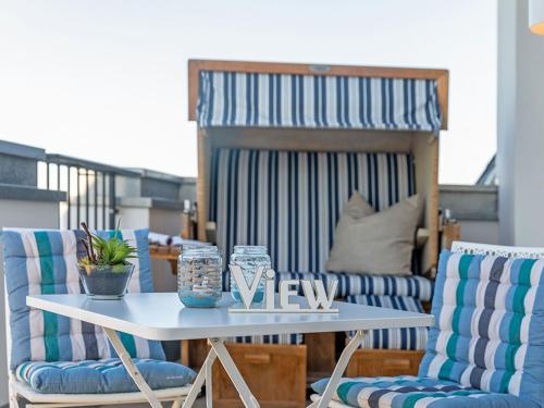 a table and chairs in a room with a bed at FIRST Sellin - Meerblick-Suite "View" in Ostseebad Sellin