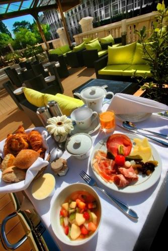 a table with plates of food on top at Hôtel Princesse Flore in Royat