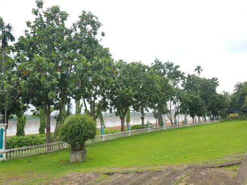 a park with a tree in the middle of a field at Royal Mekong Riverside Hotel in Nong Khai