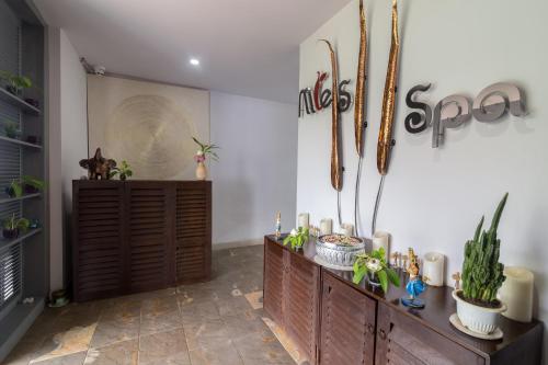 a room with a wooden cabinet with plants on it at Damrei Residence & Spa in Siem Reap
