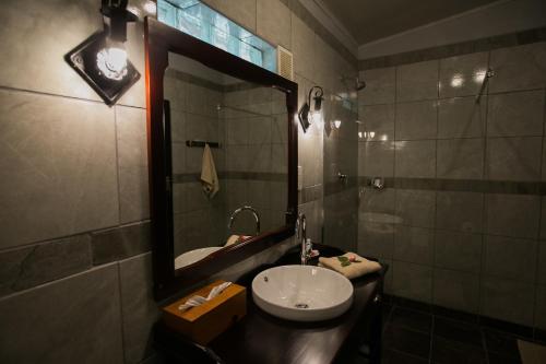a bathroom with a sink and a mirror at Island Safari Lodge in Maun
