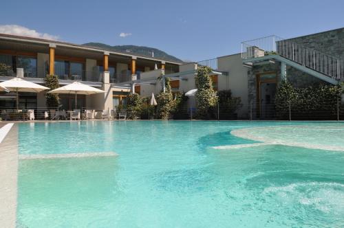 a swimming pool in front of a hotel at Tullio Hotel in Gravedona