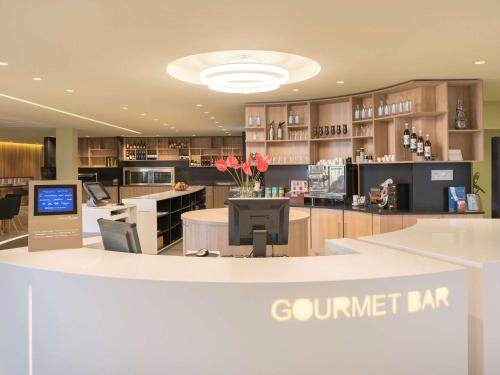 a kitchen with a counter top with a counter top at Novotel Paris Nord Expo Aulnay in Aulnay-sous-Bois