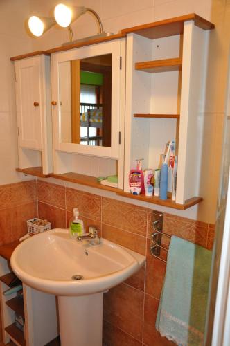 a bathroom with a sink and a mirror at Apartamento en Isaba (NAVARRA) in Isaba