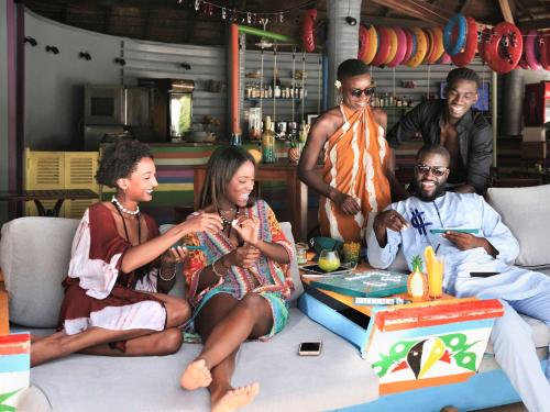a group of people sitting around a table with a cake at Pullman Dakar Teranga in Dakar