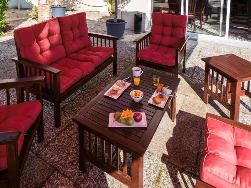 a group of chairs and a table with a tray of food at Ibis Château-Thierry in Essômes-sur-Marne