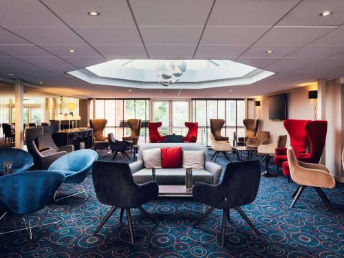 a waiting room with a couch and chairs at Novotel Nottingham Derby in Long Eaton