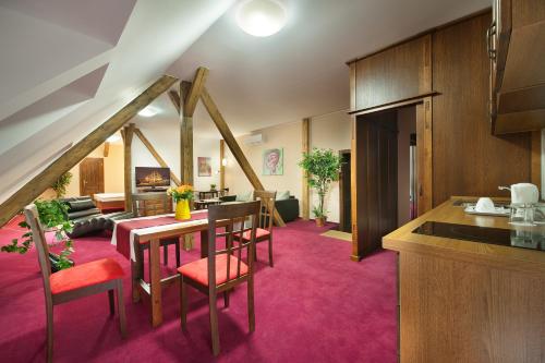 a kitchen and living room with a table and chairs at Brioni Suites in Ostrava