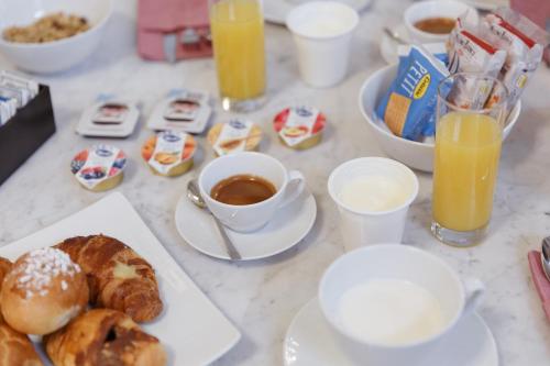 a table with breakfast foods and drinks on it at Il Salotto della Regina in Naples