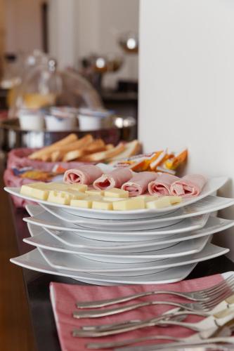 a stack of plates with food on top at Il Salotto della Regina in Naples