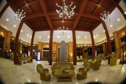 a large lobby with chairs and a chandelier at KMA Bagan Hotel River View in Bagan