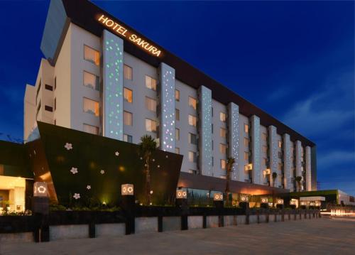 a hotel building with a sign on the side of it at Sakura Park Hotel & Residence in Cikarang