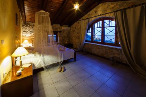 a bedroom with a bed in a room with a window at Villa Melite in Agios Nikolaos