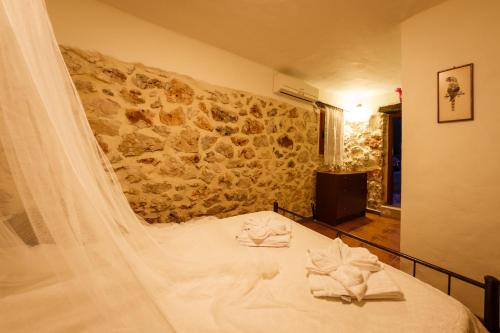 a bedroom with a bed with towels on it at Villa Melite in Agios Nikolaos